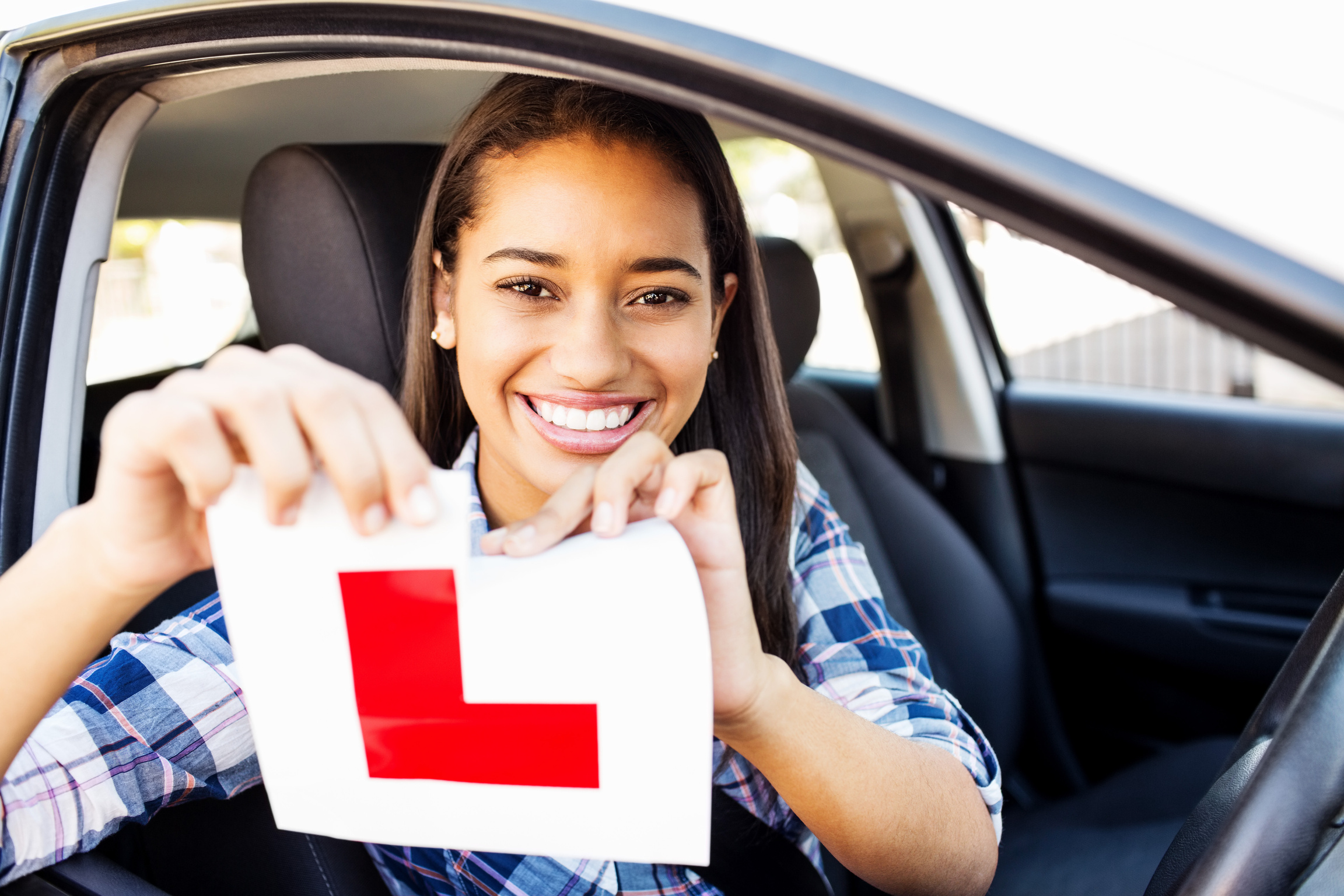 Teenage Girl Tearing L Plate After Passing Driving Test